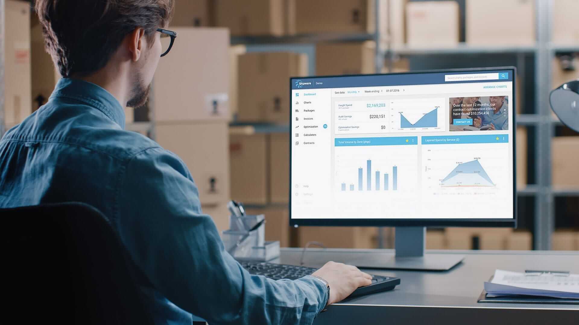man at computer calculating bulk shipping rates using Shipware